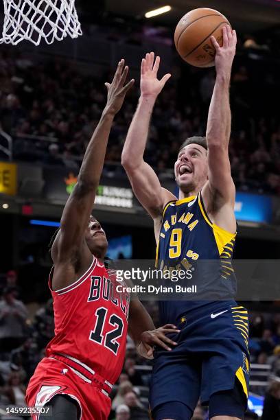 McConnell of the Indiana Pacers attempts a shot while being guarded by Ayo Dosunmu of the Chicago Bulls in the third quarter of the game at...