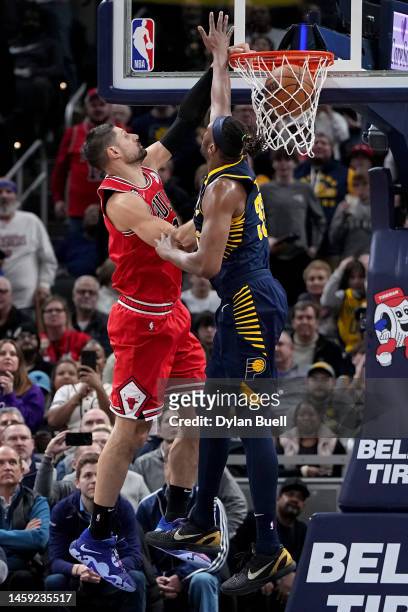 Nikola Vucevic of the Chicago Bulls dunks the ball past Myles Turner of the Indiana Pacers in the fourth quarter of the game at Gainbridge Fieldhouse...