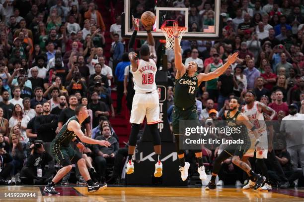 Bam Adebayo of the Miami Heat attempts a jump shot while being defended by Grant Williams of the Boston Celtics during the second half of the game at...