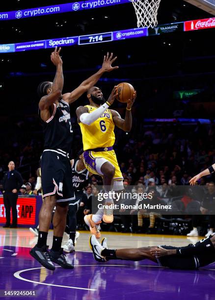 LeBron James of the Los Angeles Lakers takes a shot against Kawhi Leonard of the LA Clippers in the first half at Crypto.com Arena on January 24,...