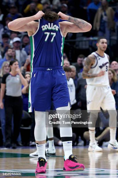 Luka Doncic of the Dallas Mavericks rips his jersey while reacting against the Washington Wizards late in the fourth quarter at American Airlines...