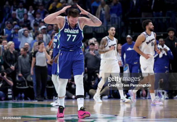 Luka Doncic of the Dallas Mavericks rips his jersey while reacting against the Washington Wizards late in the fourth quarter at American Airlines...