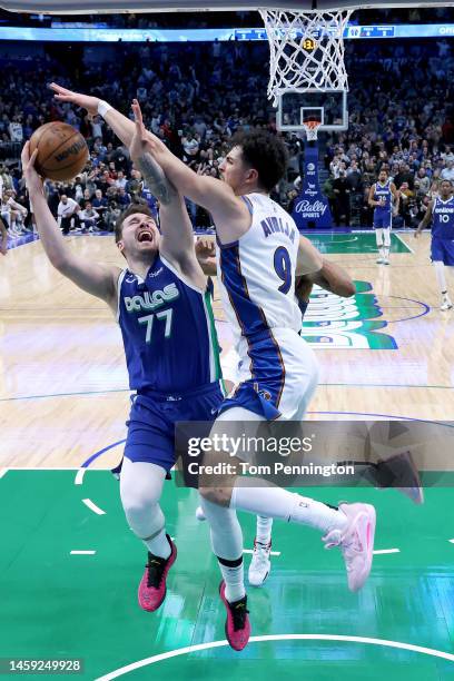 Luka Doncic of the Dallas Mavericks drives to the basket against Deni Avdija of the Washington Wizards in the fourth quarter at American Airlines...