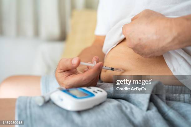 Diabetic Injecting A Diabetic Injecting Himself With Insulin Photos and Premium High Res ...