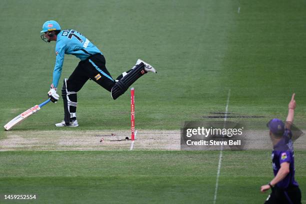 Matthew Renshaw of the Heat is runout by Zac Crawley of the Hurricanes during the Men's Big Bash League match between the Hobart Hurricanes and the...