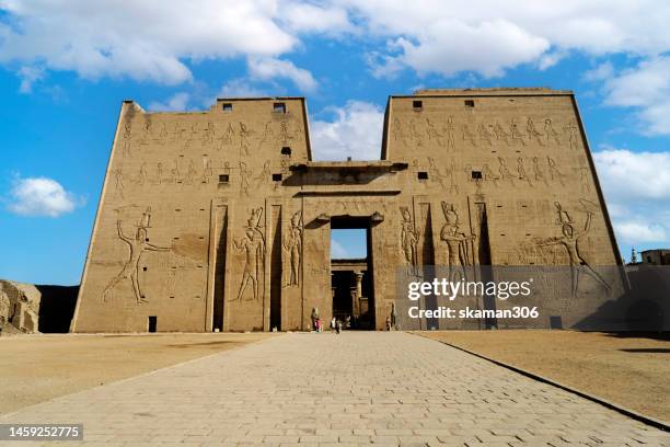 ruin stone carving god horus and osiris at edfu temple near nile river egypt - テーベ ストックフォトと画像