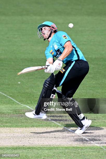 Sam Hain of the Heat is struck by the ball during the Men's Big Bash League match between the Hobart Hurricanes and the Brisbane Heat at University...