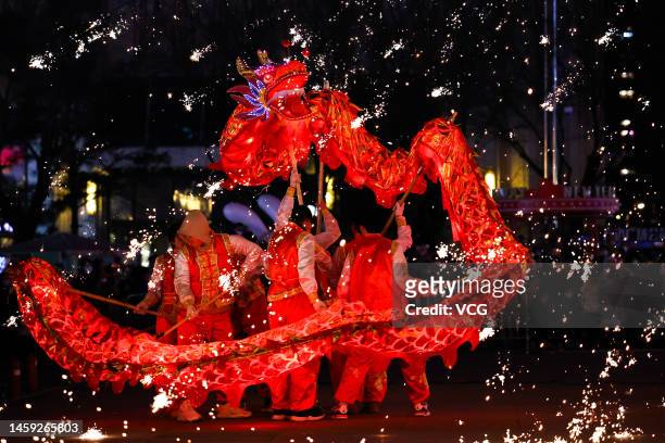 Folk artists perform fire dragon dance in a shower of molten iron sparkling on the street during the Spring Festival holiday on January 24, 2023 in...