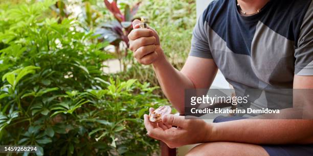 unrecognizable man with a pipe and a lighter in the garden - green lighter stock pictures, royalty-free photos & images
