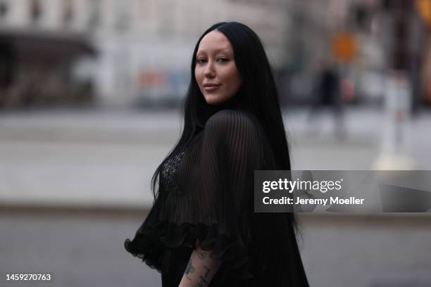 Noah Cyrus is seen wearing a transparent black long dress and white bra during the Paris Fashion Week - Haute Couture Spring Summer 2023 - Day Two on...