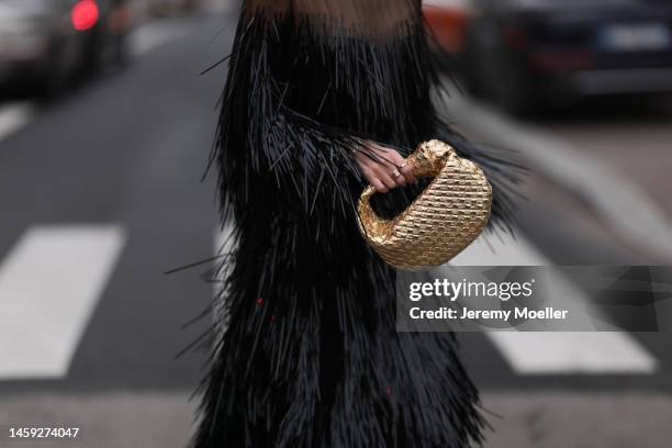 Leonie Hanne is seen wearing a black shades, black transparent midi dress, Bottega Veneta gold metallic Jodie bag and matching gold bootsbefore the...