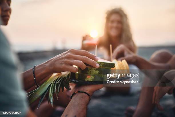 eating fresh fruit on the beach at sunset! - fat guy on beach bildbanksfoton och bilder