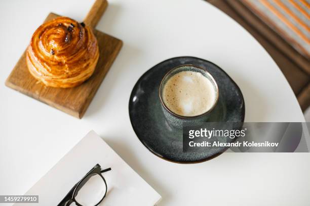 tasty breakfast with mug of latte coffee and croissant bakery on white table. directly above - boulangerie paris foto e immagini stock
