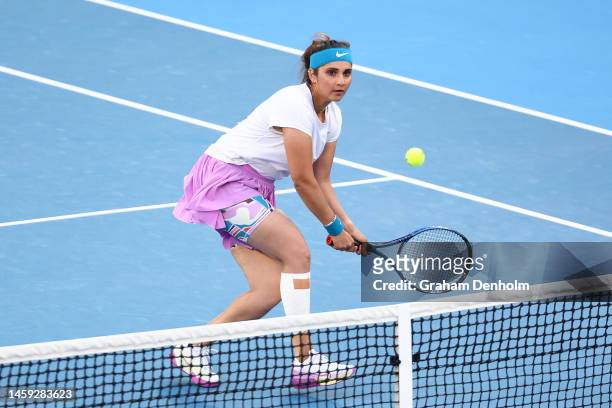 Sania Mirza of India plays a backhand in the Mixed Doubles Semifinals against Neal Skupski of Great Britain and Desirae Krawczyk of the United States...