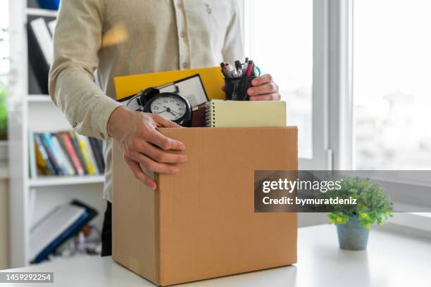 sad dismissed worker taking his office supplies with him - abdication stockfoto's en -beelden