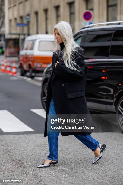 Sarah Harris wears denim jeans, black coat outside Alexandre Vauthier during Paris Fashion Week - Haute Couture Spring Summer : Day Two on January...