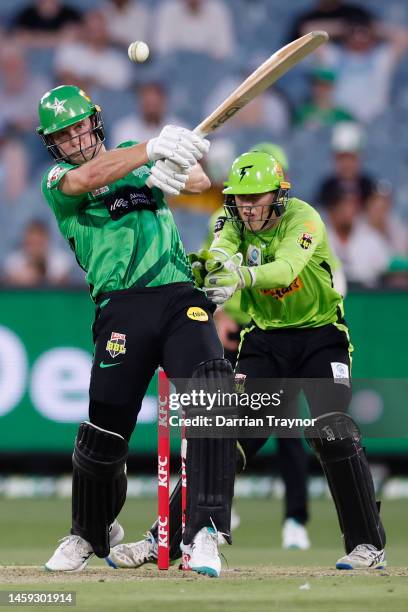 Hilton Cartwright of the Stars hits out only to be caught by Jason Sangha off the bowling of Chris Green of the Thunder during the Men's Big Bash...