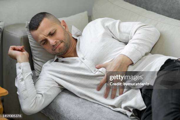 man suffering from stomach pain - hernia recovery stock pictures, royalty-free photos & images