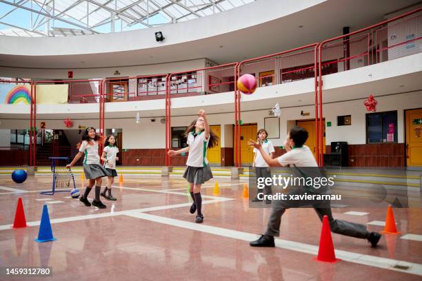 pre-adolescent boys and girls playing ball at school - recreational equipment stock pictures, royalty-free photos & images