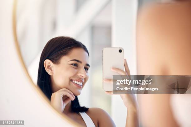 Phone, happy and selfie of woman in bathroom with smile for natural social media beauty in mirror. Reflection, happiness and skincare of wellness influencer girl with smartphone in the morning.