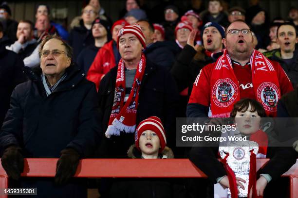 Accrington Stanley fans watch on from the terrace with a tin foil FA Cup trophy during the Emirates FA Cup Third Round Replay between Accrington...