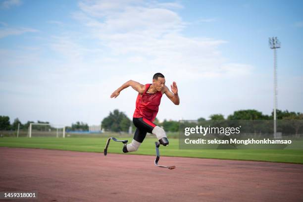 physically disabled athlete running with prosthetic legs - physically active stock pictures, royalty-free photos & images