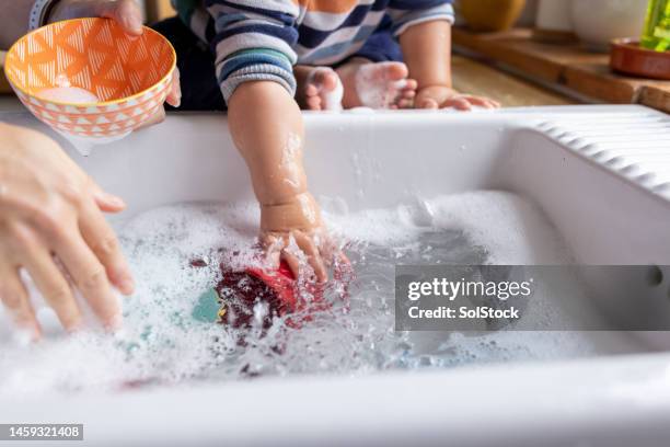 playing in the sink with mum - children water stock pictures, royalty-free photos & images