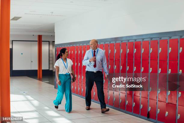 walking past the lockers - principal stock pictures, royalty-free photos & images