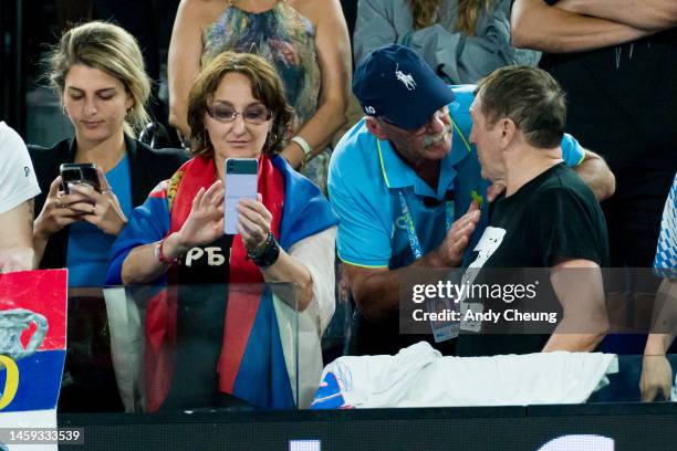 Security guard talks to a fan who wears a t-shirt with the "Z" symbol during the Quarterfinal singles match between Novak Djokovic of Serbia and...