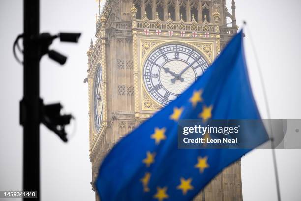 An EU flag is seen flying in front of Elizabeth Tower, commonly referred to as Big Ben, as protestors campaign against the ongoing impacts of Brexit...