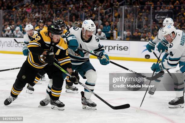 Brad Marchand of the Boston Bruins and Matt Nieto of the San Jose Sharks battle for control of the puck during the third period at TD Garden on...