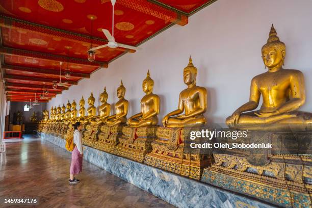 woman exploring wat pho in bangkok - buddha stock pictures, royalty-free photos & images