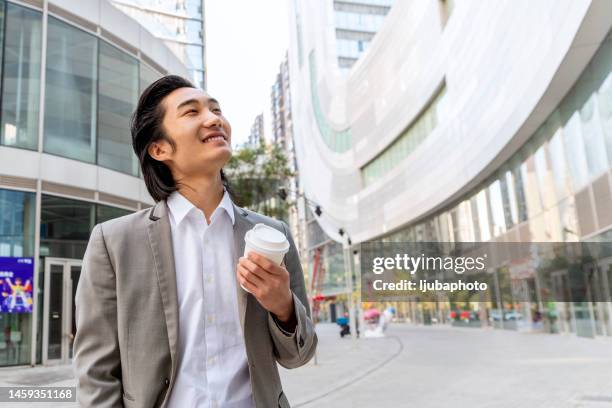 young businessman traveling through the city - happy outdoors asian stock pictures, royalty-free photos & images