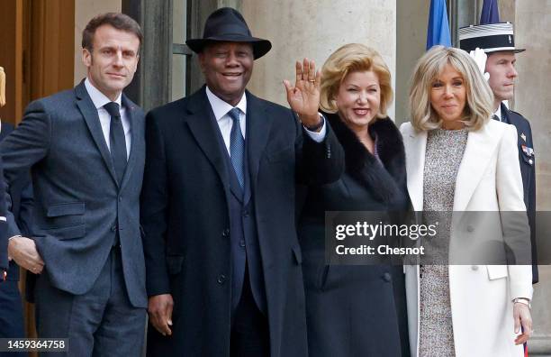 French President Emmanuel Macron and his wife Brigitte Macron pose with President Alassane Ouattara and his wife Dominique Ouattara prior to a...