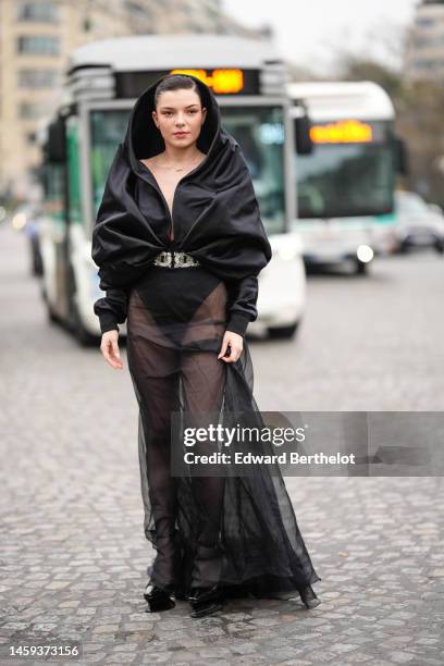 Guest wears a black hoodie / long sleeves / V-neck large body, a crystal large belt, a black tulle long skirt, black shiny leather varnished pointed...