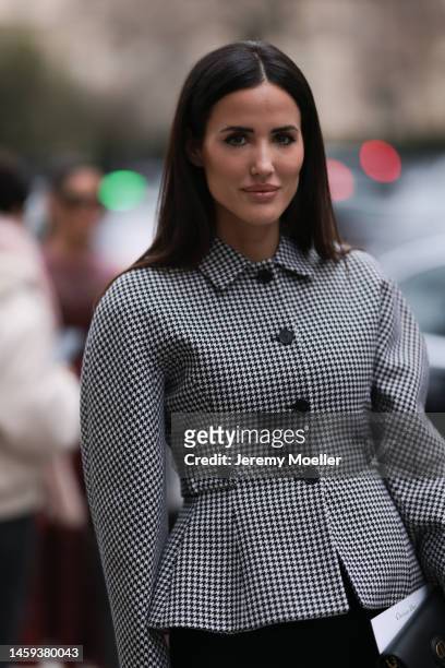Fashion week guest seen wearing a total Dior look, with a checked grey blazer jacket, a black skirt, black heels and a Dior Bobby bag before the Dior...