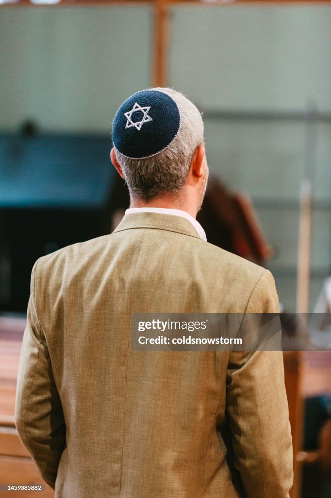 Jewish man wearing yarmulke in synagogue