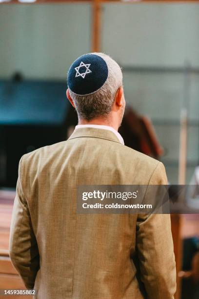 jewish man wearing yarmulke in synagogue - jewish religion stock pictures, royalty-free photos & images