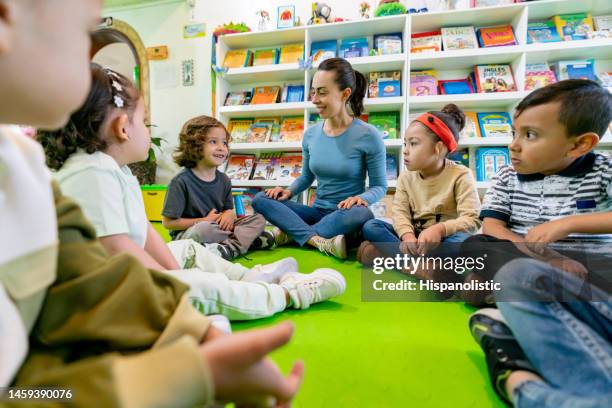 group of children at school telling stories in class to the teacher - special education stock pictures, royalty-free photos & images