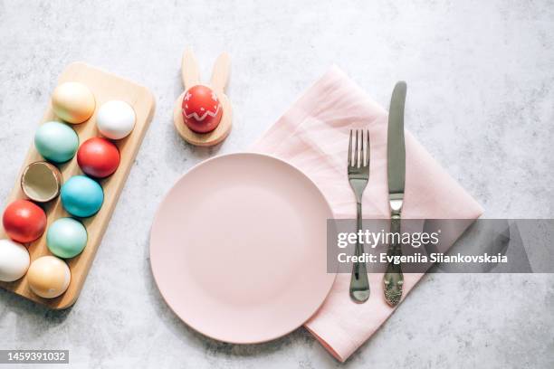 easter table setting with egg's nest, plate and cutlery. - chocolate white background stock pictures, royalty-free photos & images