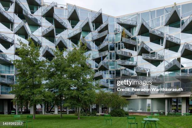 mountain dwellings, iconic apartment building with green roof and perforated aluminium plates facade. - green roof stock pictures, royalty-free photos & images