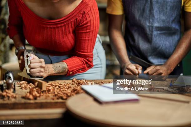 female student planing wood using metal planner at woodwork class with mentor - carving stock pictures, royalty-free photos & images