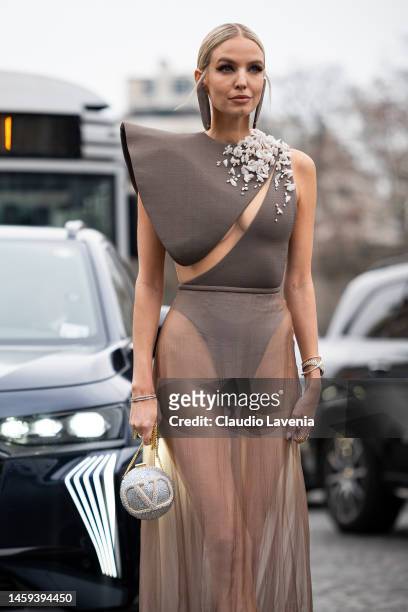 Leonie Hanne wears a taupe decorated body, nude sheer maxi skirt and Valentino bag, outside Stephane Rolland, during Paris Fashion Week - Menswear...