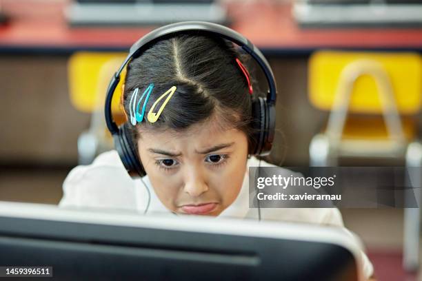 young student learning to use desktop pc in computer lab - south american girl stock pictures, royalty-free photos & images