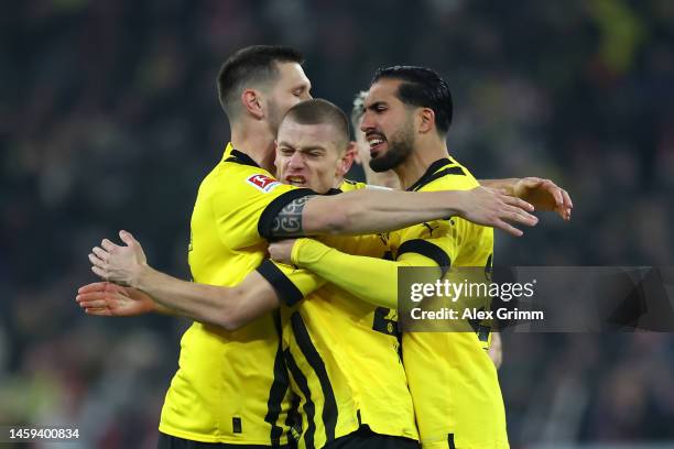 Julian Ryerson of Borussia Dortmand celebrates with team mates Emre Can and Niklas Sule after scoring their sides first goal during the Bundesliga...