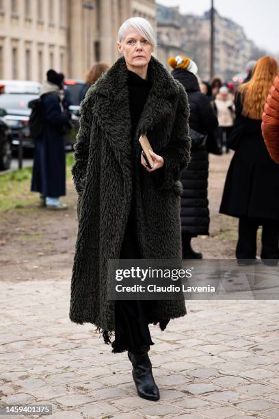 Kate Lanphear wears a military green fur coat, outside Chanel, during Paris Fashion Week - Menswear Fall-Winter 2023-2024, on January 24, 2023 in...