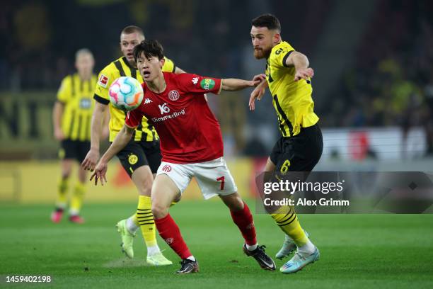 Lee Jae-Song of 1.FSV Mainz 05 is challenged by Salih Ozcan of Borussia Dortmund during the Bundesliga match between 1. FSV Mainz 05 and Borussia...