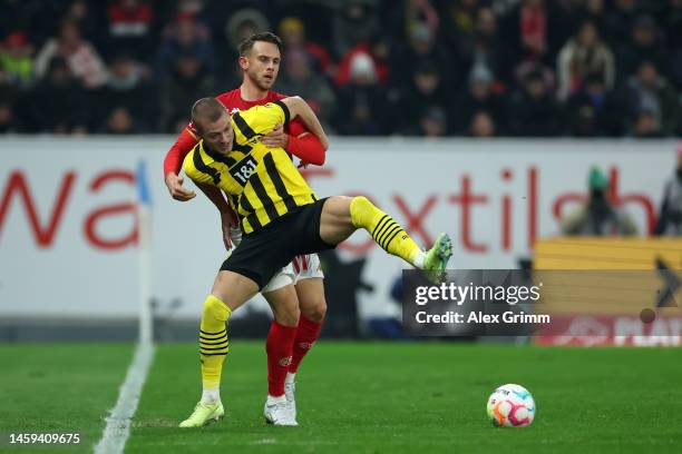 Julian Ryerson of Borussia Dortmand is challenged by Marcus Ingvartsen of 1.FSV Mainz 05 during the Bundesliga match between 1. FSV Mainz 05 and...