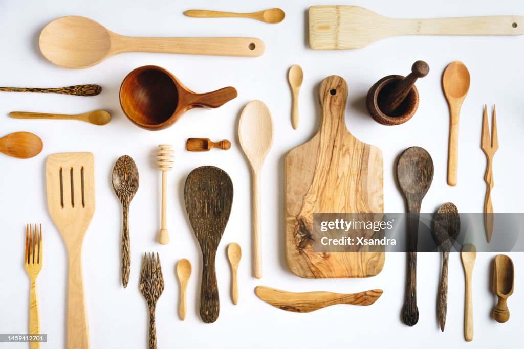 Wooden kitchen utensils on white background - knolling concept