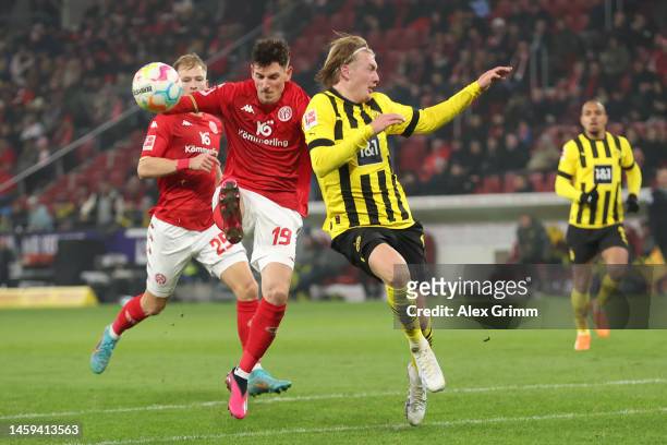 Anthony Caci of 1.FSV Mainz 05 battles for possession with Julian Brandt of Borussia Dortmund during the Bundesliga match between 1. FSV Mainz 05 and...